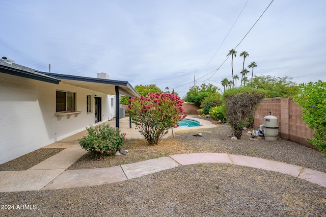 view of yard with a fenced in pool and a patio