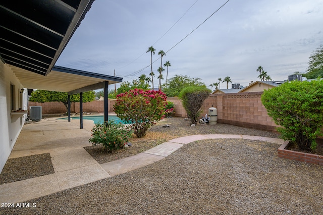 view of yard with a fenced in pool, a patio, and central AC