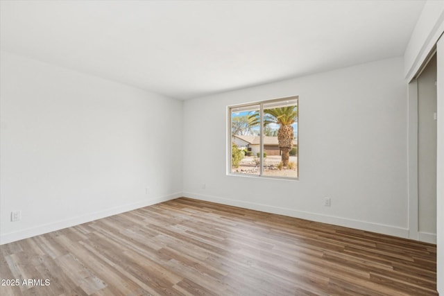 4829 E Apache Cir, Phoenix, AZ 85044 - unfurnished bedroom with wood finished floors and a closet