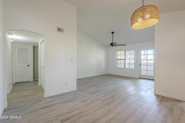 6885 E Cochise Rd Unit 219, Paradise Valley, AZ 85253 - unfurnished room featuring high vaulted ceiling, arched walkways, ceiling fan, and light wood-style flooring