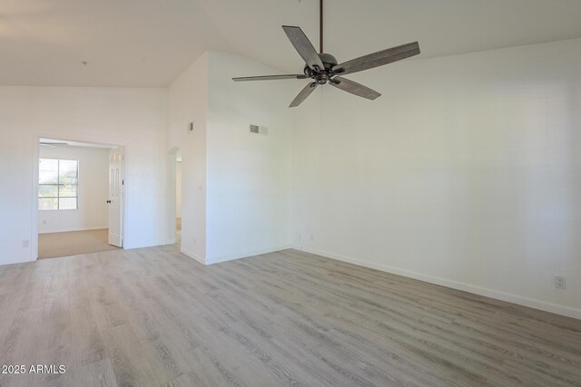 6885 E Cochise Rd Unit 219, Paradise Valley, AZ 85253 - spare room with wood finished floors, ceiling fan, arched walkways, and high vaulted ceiling