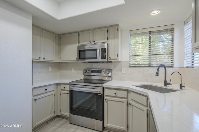 6885 E Cochise Rd Unit 219, Paradise Valley, AZ 85253 - kitchen with stainless steel appliances, light countertops, tasteful backsplash, light wood finished floors, and recessed lighting