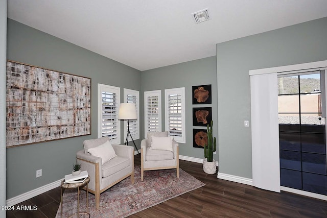 sitting room with dark wood-type flooring