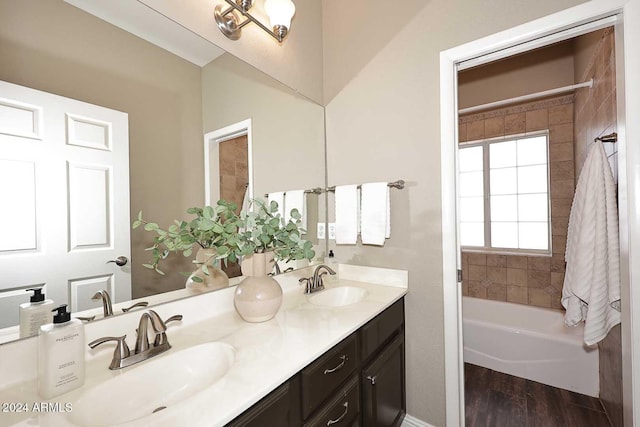 bathroom featuring wood-type flooring, vanity, and a bathing tub