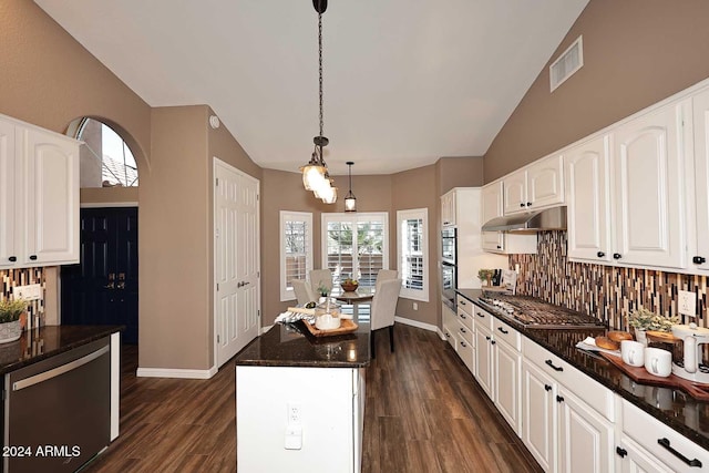 kitchen with white cabinetry, stainless steel appliances, dark hardwood / wood-style floors, backsplash, and decorative light fixtures