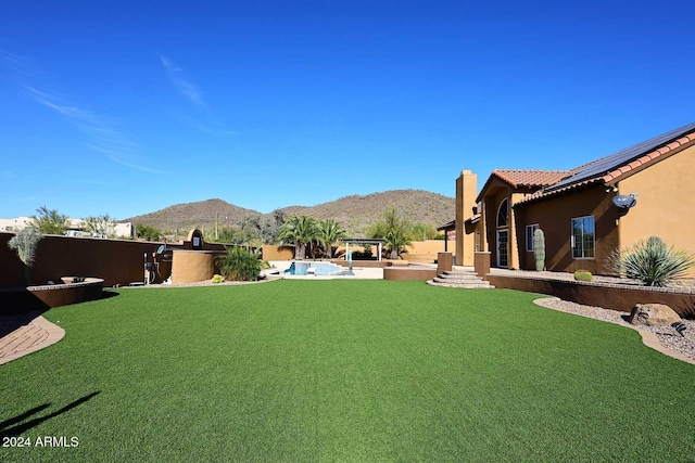 view of yard featuring a mountain view, a fenced in pool, and a patio area