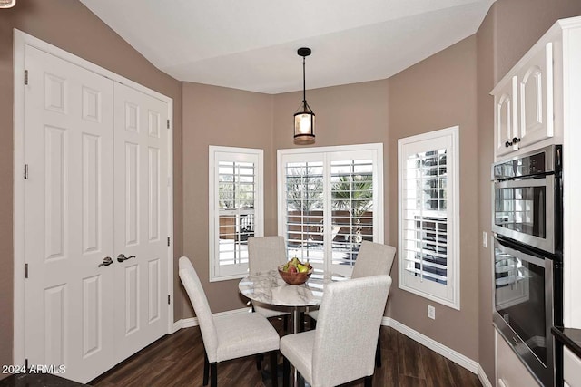 dining area with dark hardwood / wood-style floors and lofted ceiling