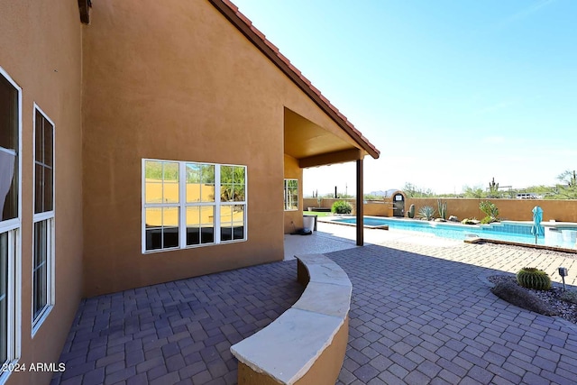 view of patio / terrace with a fenced in pool