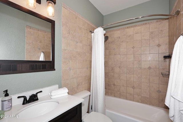 full bathroom featuring vanity, shower / bathtub combination with curtain, and toilet