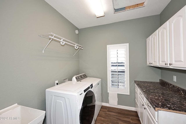 laundry area featuring cabinets, sink, and washing machine and clothes dryer