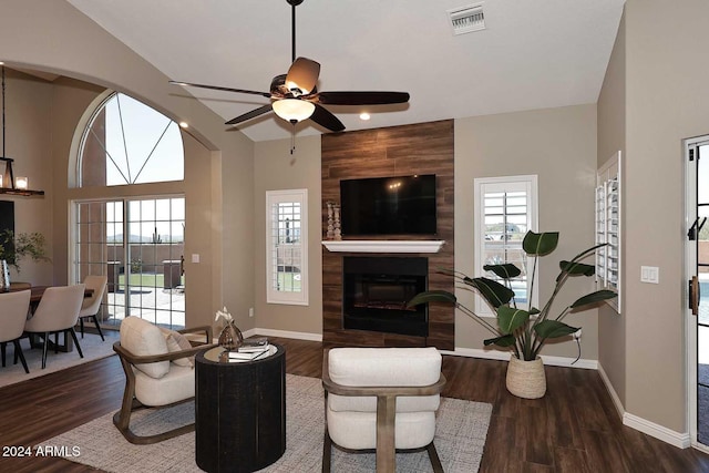 living room featuring ceiling fan, a fireplace, wood-type flooring, and plenty of natural light