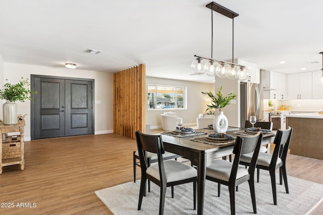 dining space featuring light hardwood / wood-style floors