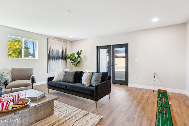 living room with light hardwood / wood-style flooring and french doors