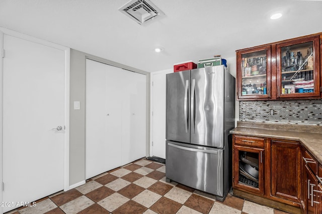 3608 W Harrison St, Chandler, AZ 85226 - kitchen featuring freestanding refrigerator, backsplash, glass insert cabinets, and recessed lighting