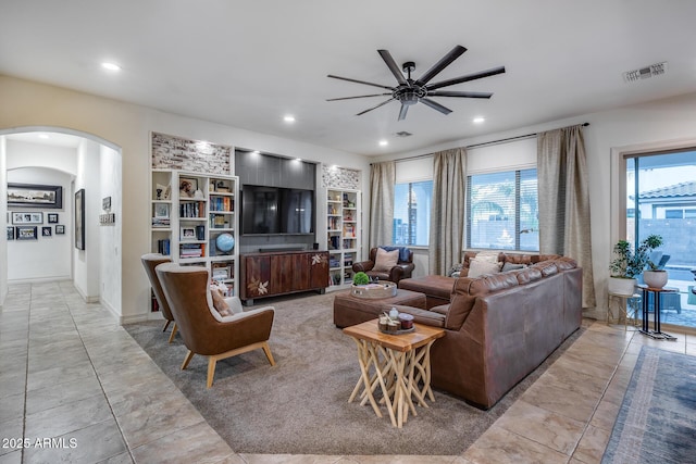 20125 E Via Del Rancho, Queen Creek, AZ 85142 - living room with visible vents, built in shelves, recessed lighting, a ceiling fan, and arched walkways
