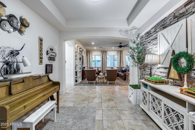 20125 E Via Del Rancho, Queen Creek, AZ 85142 - hall with arched walkways, a tray ceiling, and light tile patterned flooring