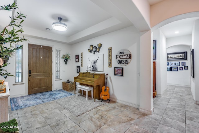 20125 E Via Del Rancho, Queen Creek, AZ 85142 - entryway featuring arched walkways, baseboards, a tray ceiling, and visible vents