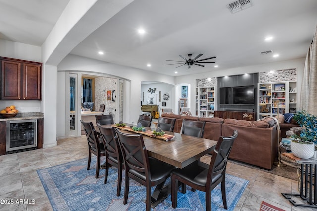 20125 E Via Del Rancho, Queen Creek, AZ 85142 - dining area with visible vents, ceiling fan, wine cooler, recessed lighting, and arched walkways