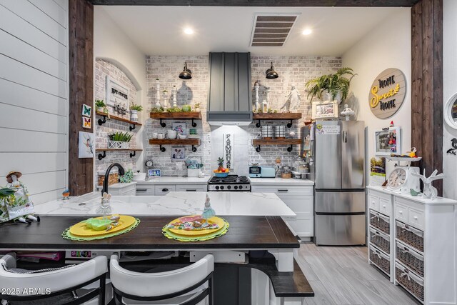 20125 E Via Del Rancho, Queen Creek, AZ 85142 - kitchen with open shelves, visible vents, freestanding refrigerator, a peninsula, and ventilation hood