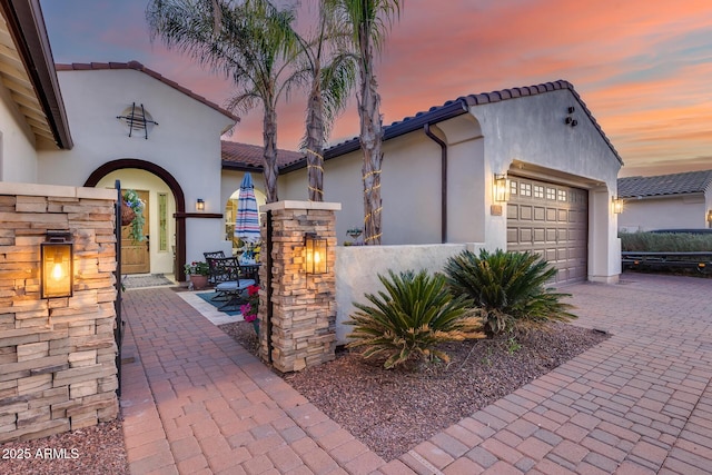 20125 E Via Del Rancho, Queen Creek, AZ 85142 - mediterranean / spanish-style home featuring a tile roof, a garage, decorative driveway, and stucco siding