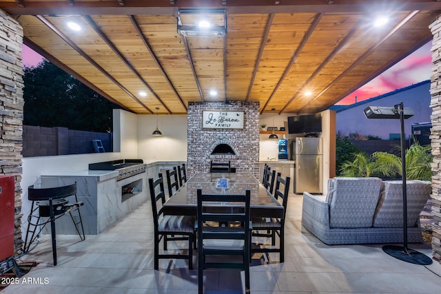 20125 E Via Del Rancho, Queen Creek, AZ 85142 - dining space with exterior fireplace, light tile patterned floors, wooden ceiling, and beam ceiling