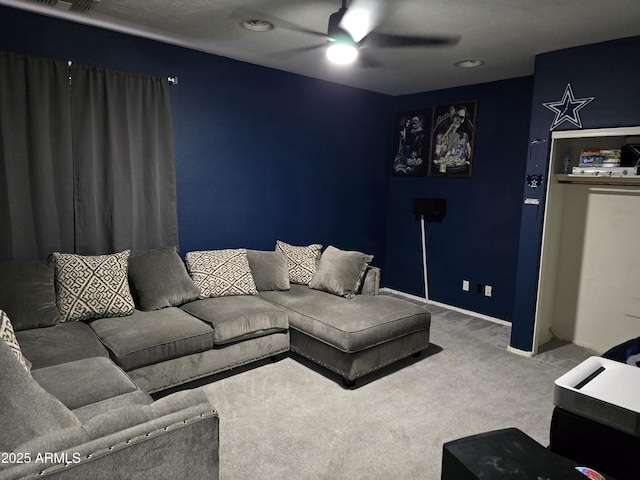 living room with ceiling fan and carpet