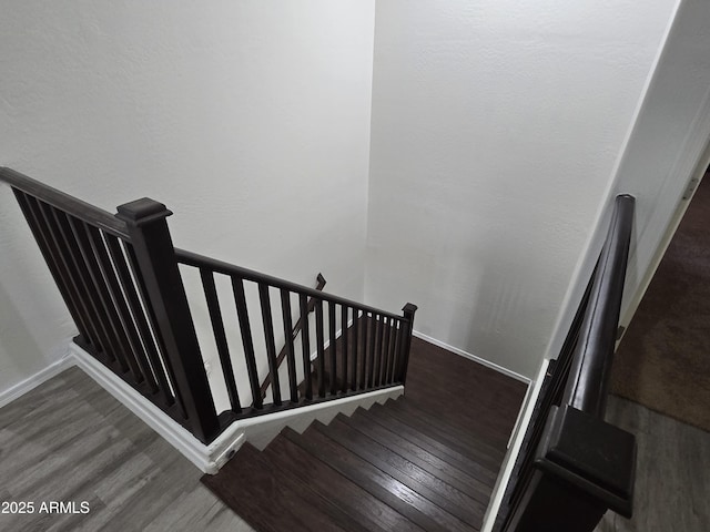 stairs with baseboards and wood finished floors