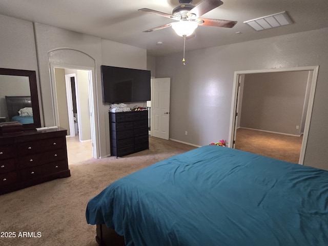 bedroom with light carpet, baseboards, visible vents, and a ceiling fan