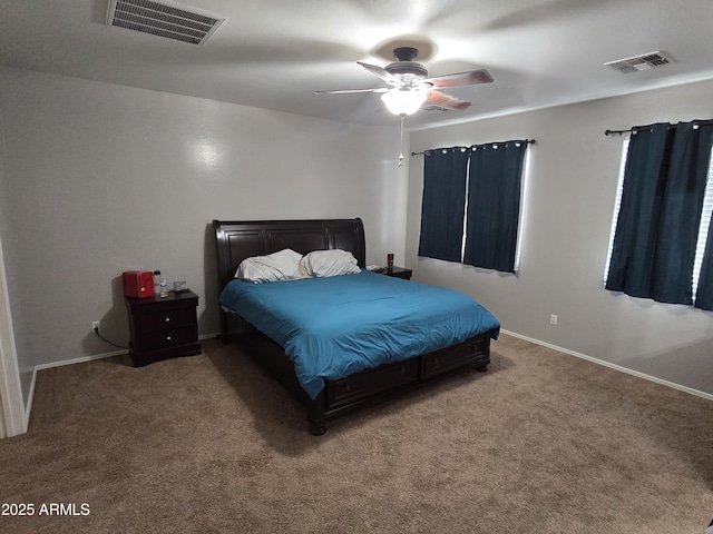 carpeted bedroom with a ceiling fan, visible vents, and baseboards