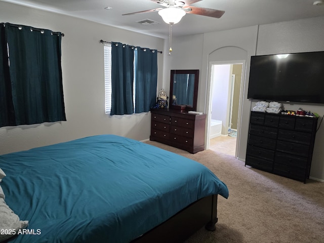 bedroom with visible vents, ceiling fan, carpet flooring, and ensuite bathroom