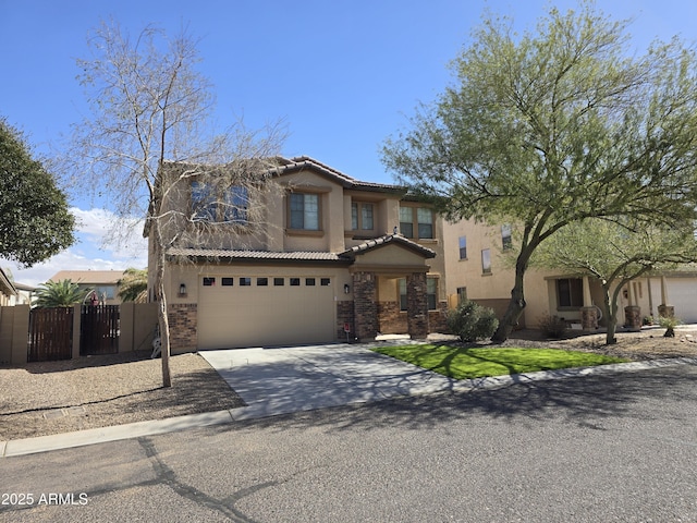 view of front of house with driveway, a tiled roof, a gate, and stucco siding