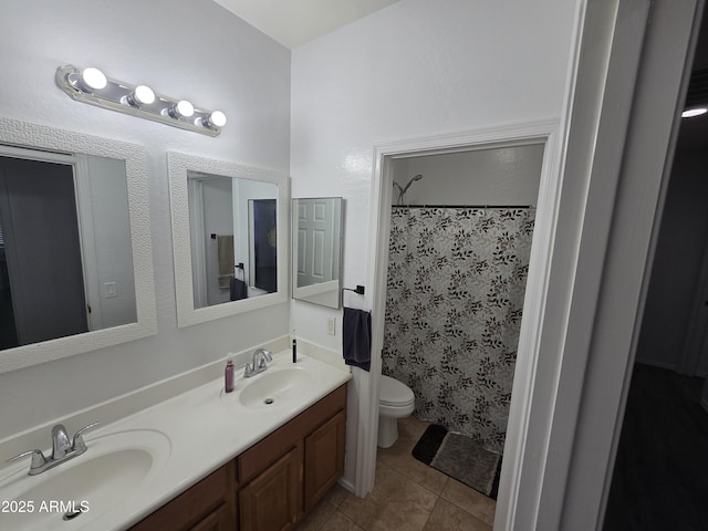 full bathroom with double vanity, a sink, toilet, and tile patterned floors