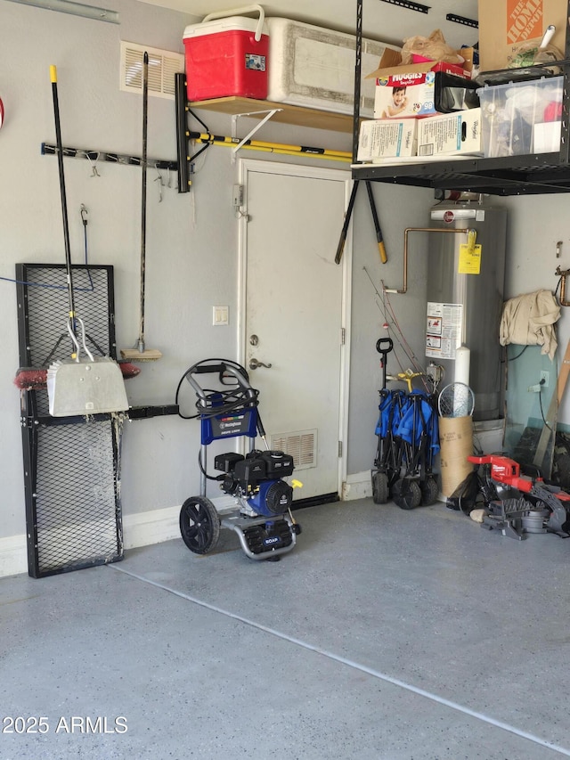 garage with gas water heater and visible vents