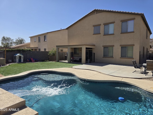 view of swimming pool featuring a patio area, a fenced backyard, a fenced in pool, and a yard