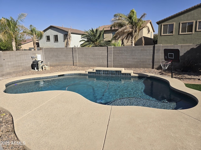 view of swimming pool featuring a patio, a fenced backyard, and a fenced in pool