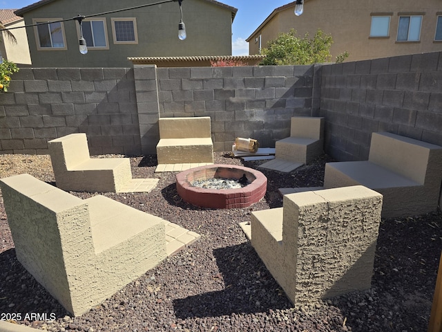 view of patio / terrace with a fenced backyard and a fire pit