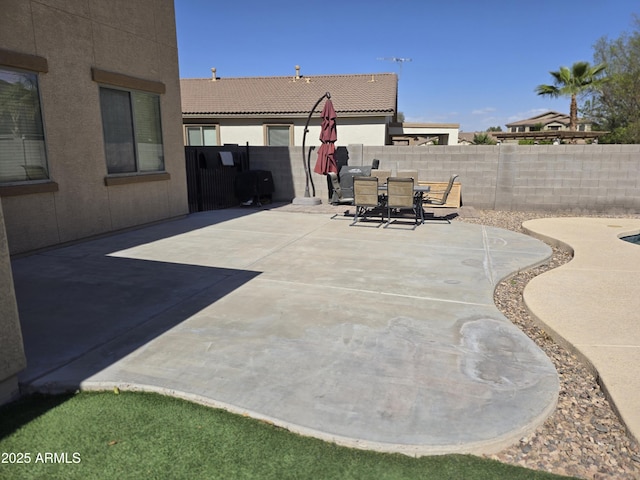 view of patio featuring a fenced backyard and outdoor dining area