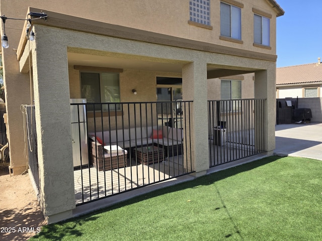 back of property with fence and stucco siding