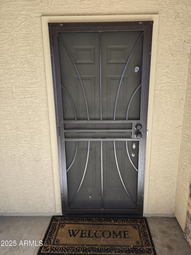 doorway to property with stucco siding