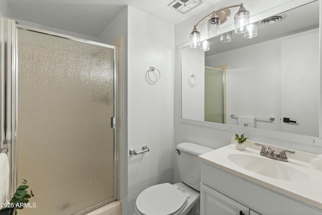 bathroom with vanity, an enclosed shower, and toilet