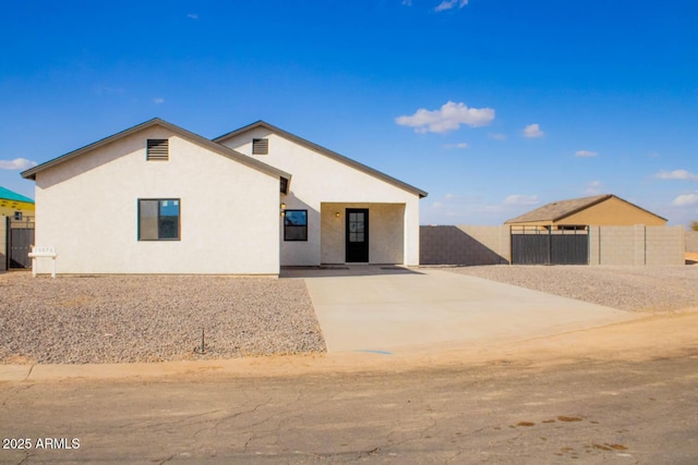 back of house with fence and stucco siding