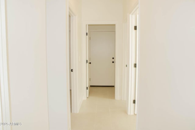 hall featuring light tile patterned floors