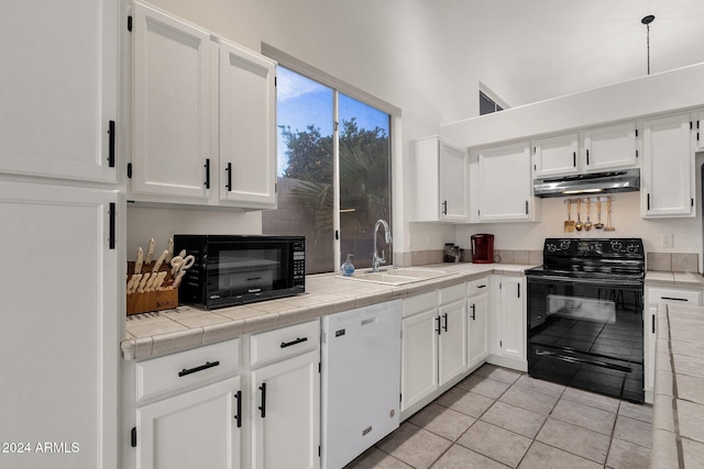 kitchen with tile countertops, sink, white cabinets, and black appliances