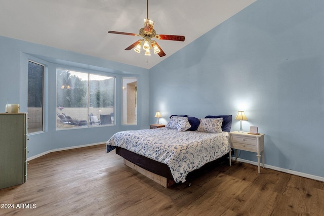 bedroom featuring ceiling fan, wood-type flooring, and vaulted ceiling