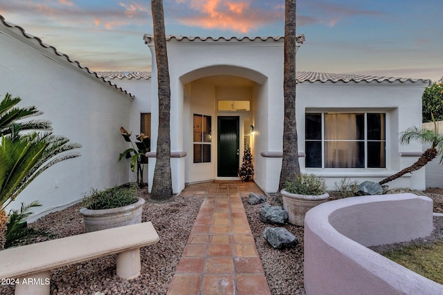 view of exterior entry at dusk