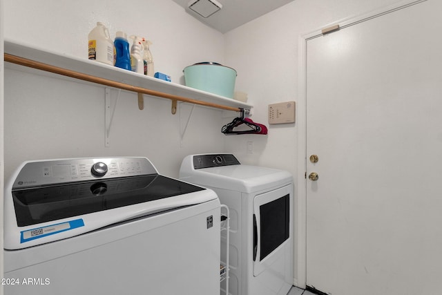 clothes washing area featuring washer and clothes dryer