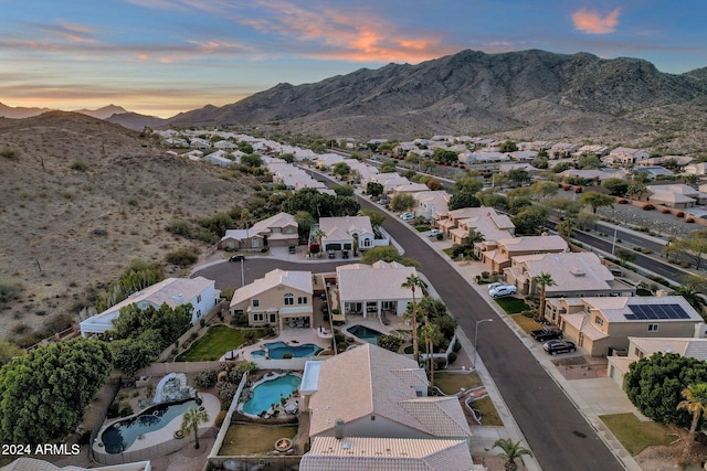 aerial view at dusk featuring a mountain view