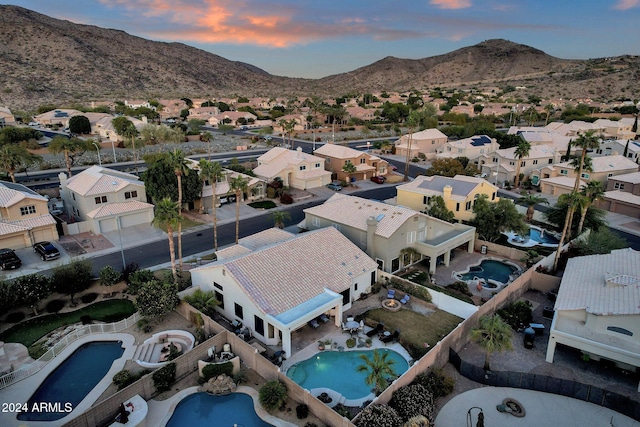 aerial view at dusk featuring a mountain view