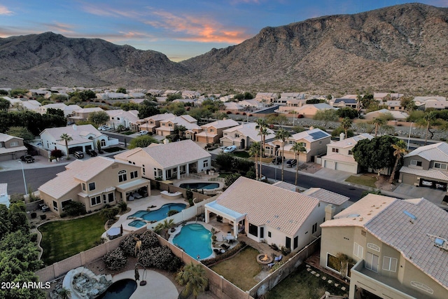 aerial view at dusk featuring a mountain view