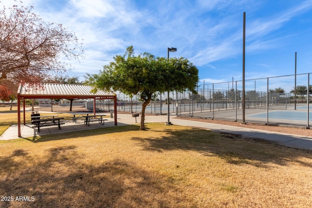 view of community featuring a gazebo, a lawn, and tennis court